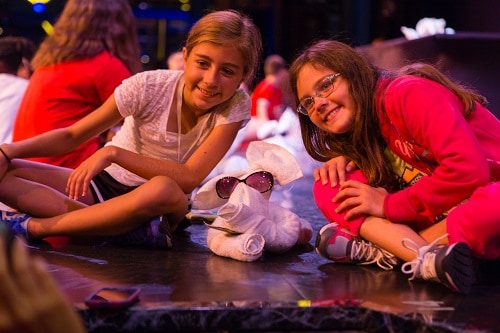 two girls smiling with their towel animal at the towel animal theater