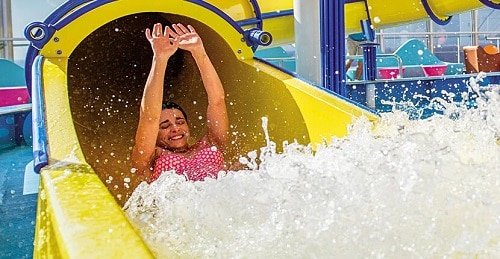 woman coming down from the twister waterslide