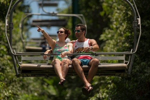 couple riding on a sky lift as part of a shore excursion in the caribbean