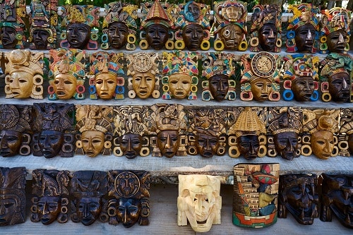 rows of wooden masks on display in ensenada