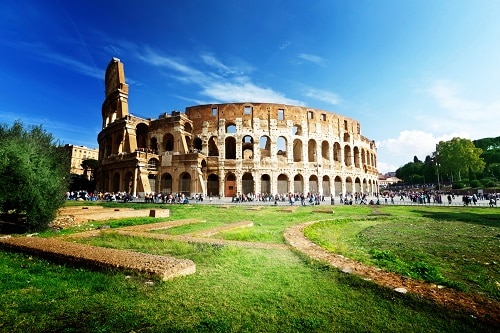 the sun shining down on the roman colosseum