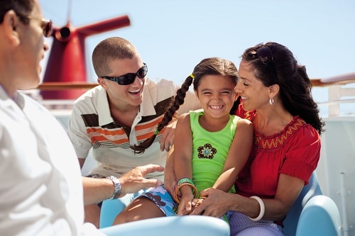 family enjoying their time on a deck onboard a carnival cruise ship