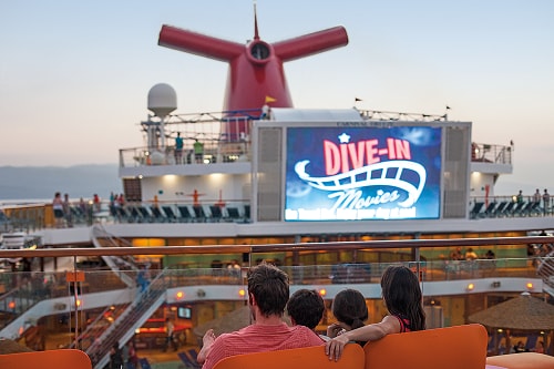 family settling in to start watching a feature movie onboard a carnival ship