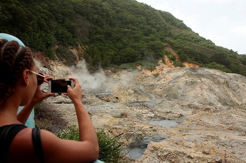girl taking a photo of the mountains in st. lucia