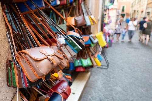 leather bags on display at an italian marketplace