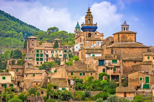 a wide view of the tall buildings of valldemossa, a historic village in palma de mallorca