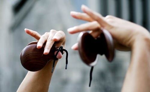 hands of a woman playing flamenco castanets in spain
