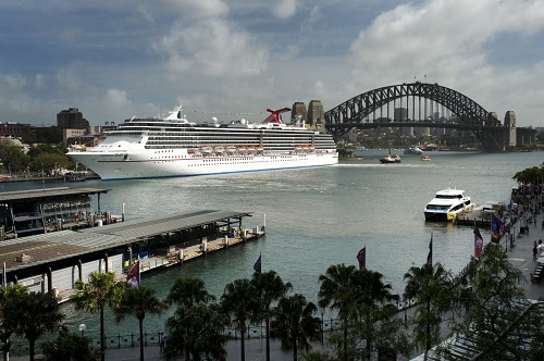 a carnival ship sailing through sydney, australia