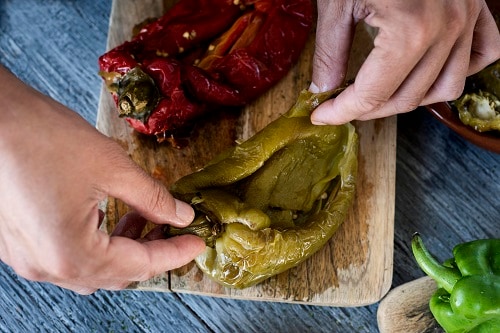 a chef preparing peppers for escalivada
