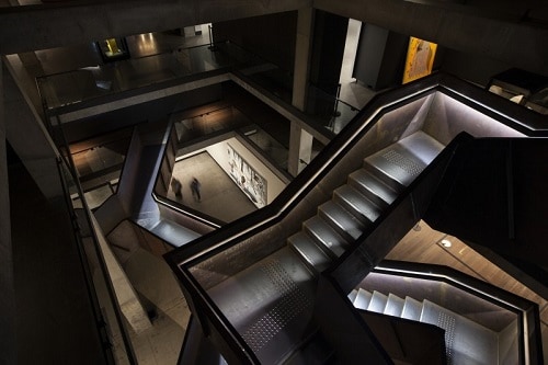 corten stairwell and surrounding gallery at an art museum