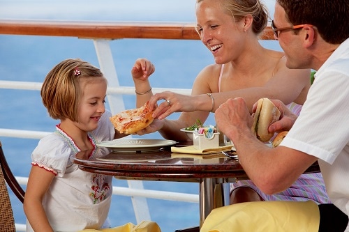 little girl eating pizza on a cruise ship with her family