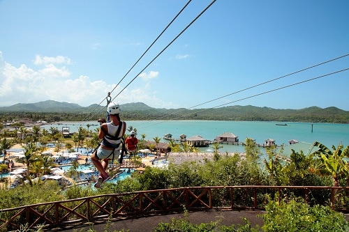 two people zip lining at a resort in amber cove