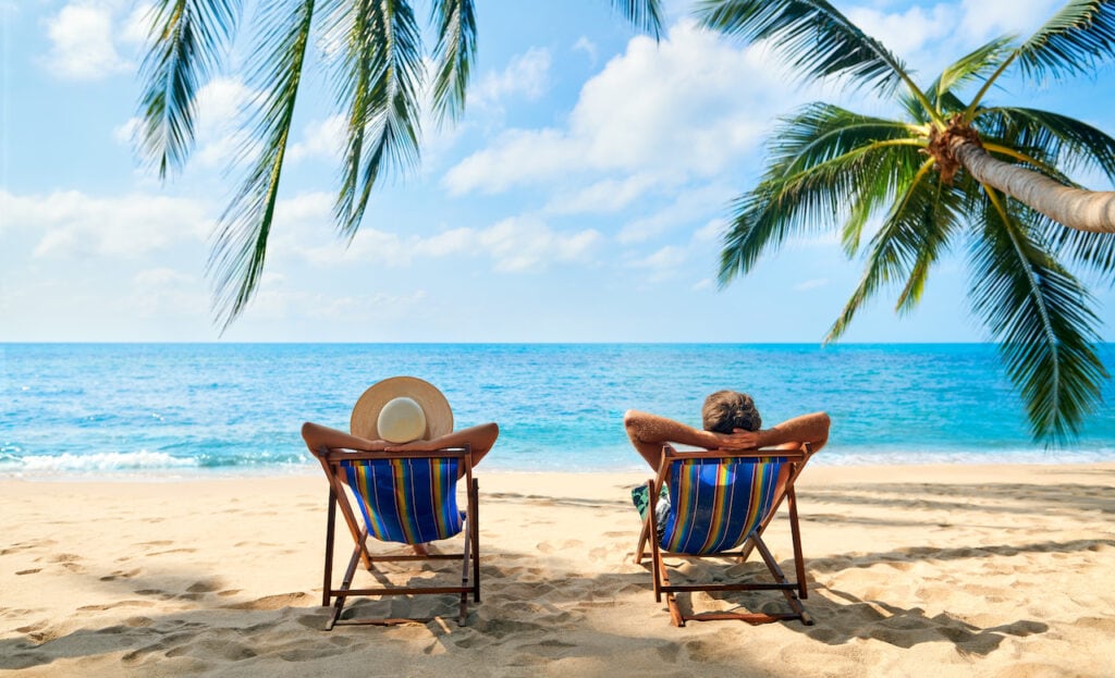 Couple relaxing on chairs on a beach