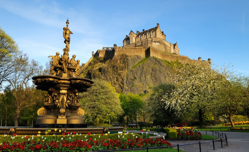 A view of the iconic Edinburgh Castle, looking up from Princess Street gardens with the Ross fountain in the foreground.
